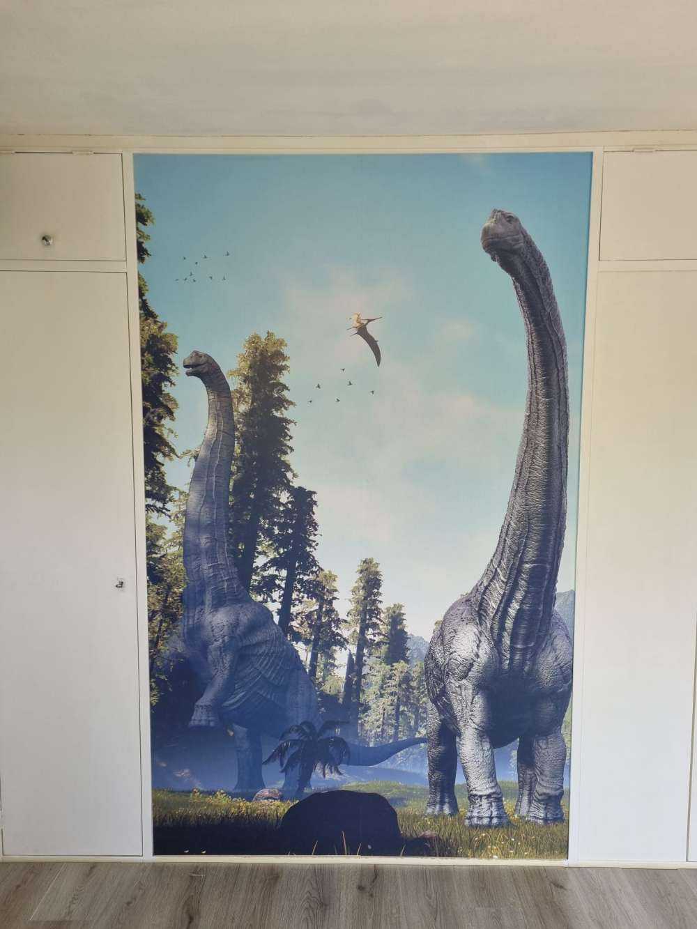 Groupe d'Alamosaurus marchant dans une vallée