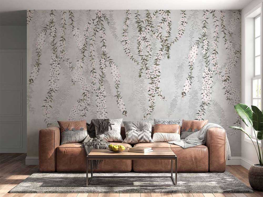 Branches de fleurs sur un mur en béton bleu clair